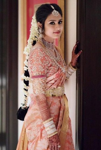 South Indian bride in pastel pink saree