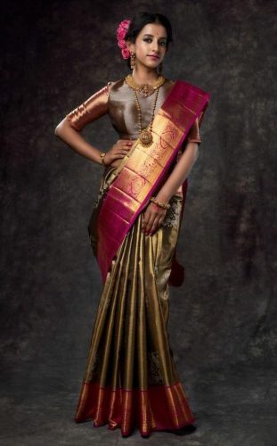 South Indian bride in copper saree with pink border