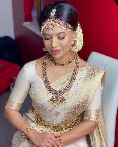 South Indian bride in white and gold pattu saree