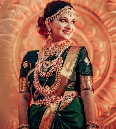 South Indian bride in dark green Kanjivaram saree