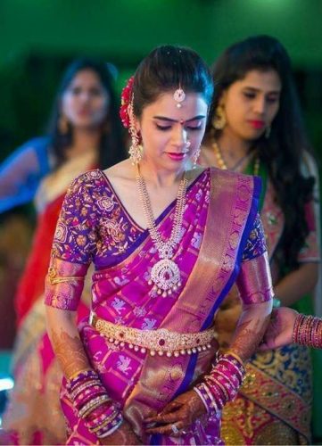 South Indian bride in purple and pink saree