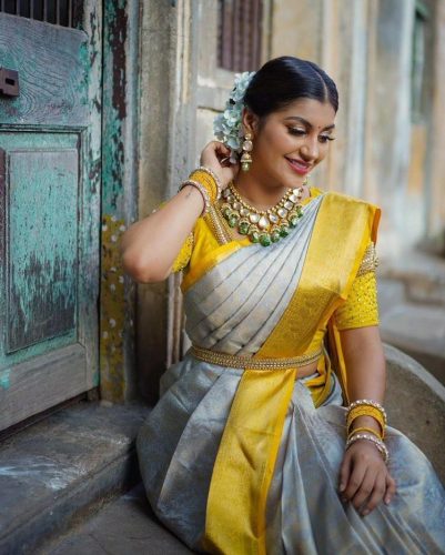 South Indian bride in silver and yellow saree