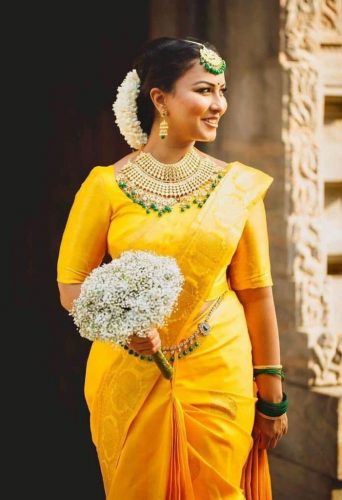 South Indian bride in yellow silk saree