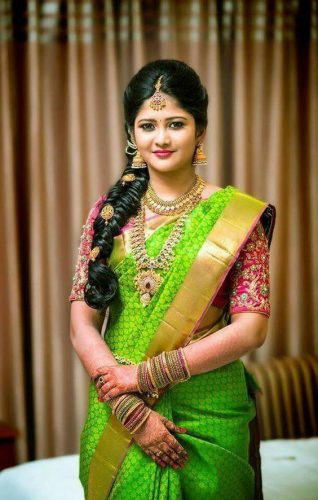 South Indian bride in parrot green saree with pink blouse