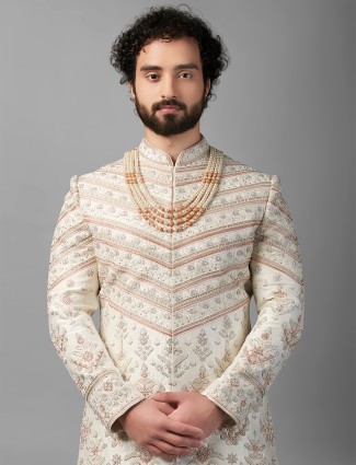 Rich cream and peach peshwai style sherwani