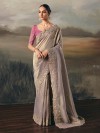 Beige tissue silk saree with ornate resham–sequins border