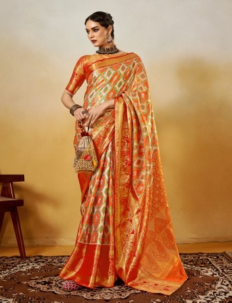 Vibrant orange silk drape with zari detailing touch