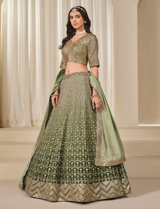 Green silk lehenga choli adorned with sequins work