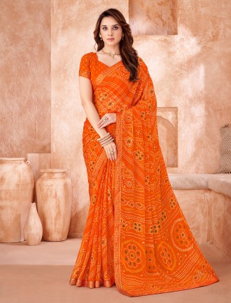 Orange chiffon saree styled with classic bandhej print