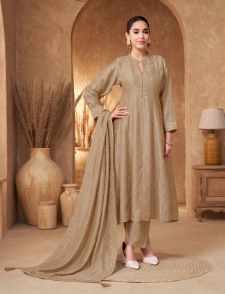 Beige silk suit with heavily worked finish