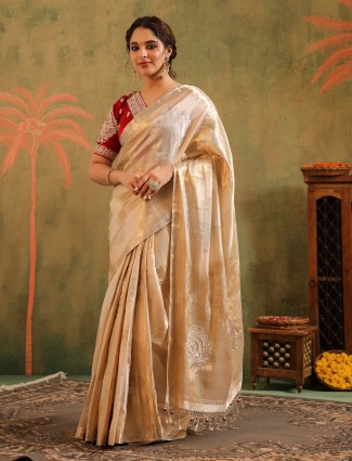 Cream silk bridal saree paired with a striking red blouse