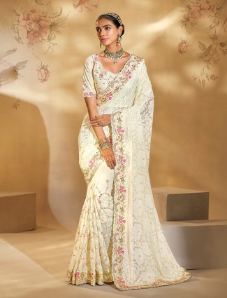 Cream georgette saree enhanced with delicate thread charm