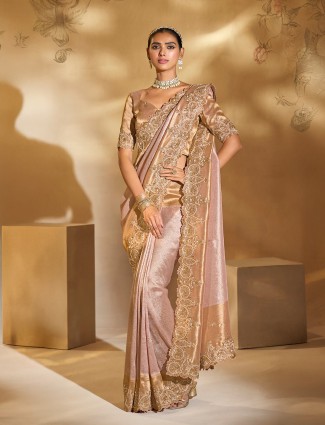 Light pink silk saree adorned with resham elegance