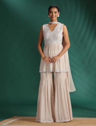Beige sharara suit with dupatta and rich embellishment