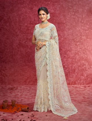 Off white net saree crafted for wedding ceremonies
