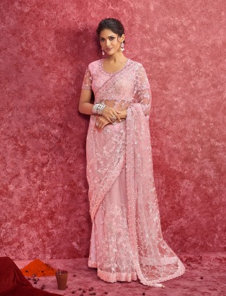 Pink net saree embellished with sequins for reception wear