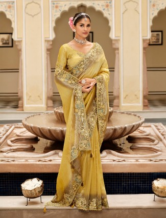 Yellow silk saree with ornate embellished border