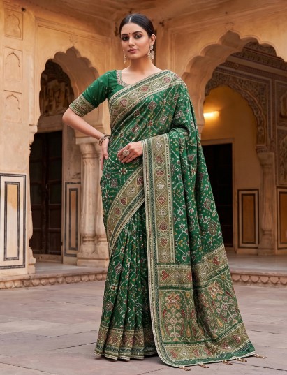 Green art patola silk saree with intricate handcrafted embellishments