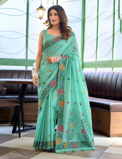 Seafoam green linen saree with artistic floral patterns