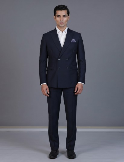 Navy blue minimal coat with defined peak lapel styling