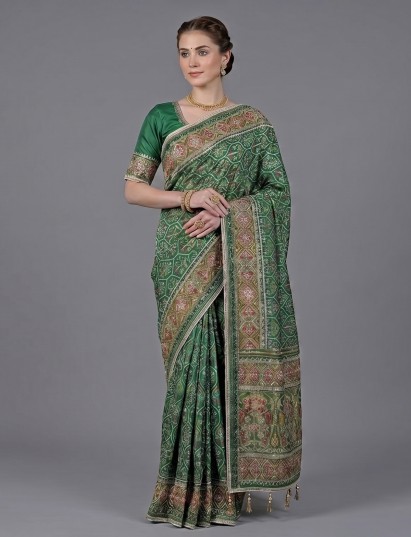 Green art patola silk saree with detailed festive embellishments
