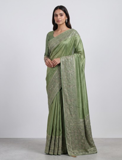 Pastel pista green shimmer dola silk saree with peacock motifs