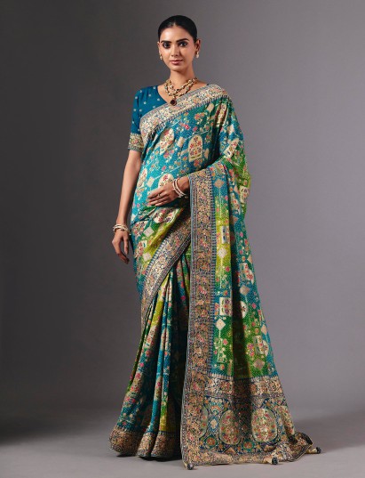 Blue dola silk saree with elegant peacock motif embellishments