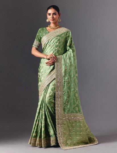 Pista green satin silk saree with ornate animal motif detailing