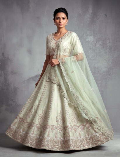 Mint green silk unstitched lehenga choli with intricate zari elegance
