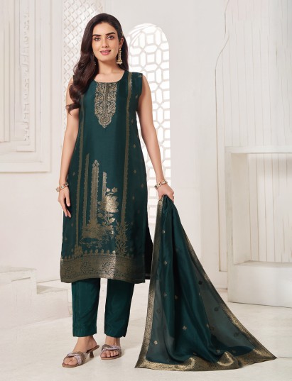 Green silk salwar suit enhanced with shimmering zari work