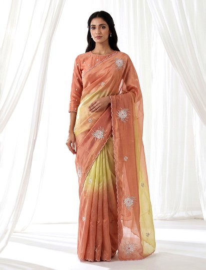 Peach shaded tissue silk designer saree with elegant festive shimmer