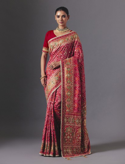 Rani pink art silk patola saree with luxurious festive craftsmanship