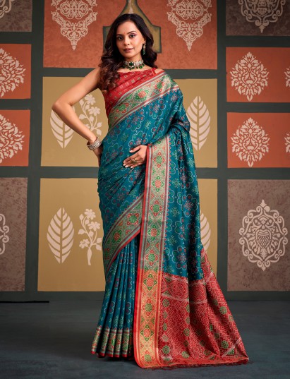 Opulent teal blue zari woven patola silk saree with contrast red blouse