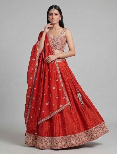Rust orange silk lehenga choli with embroidered detailing