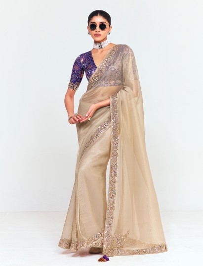 Beige tissue saree with striking contrast blouse