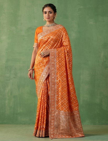 Light orange dola silk saree with festive zari jal work