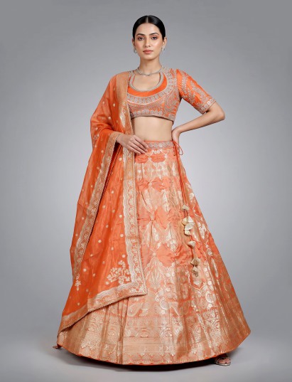 Rust orange banarasi silk lehenga choli with embellished dupatta